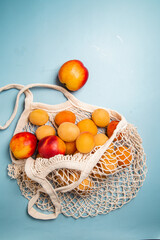 Apricots in an eco bag on a bright background. Purchase
