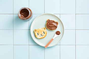 Toast with chocolate paste in the form of a panda. Children's snack. Top view, flat lay.