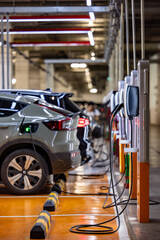 EV charging an electric car.Power supply for electric car charging. Socket for electric car battery charger. EV car charging station. Nature energy, Clean energy, Green eco concept. Plugging in cable.