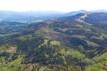 Naklejka premium Beautiful ukrainian landscape with mountains and valley on spring.Aerial view from mountain top in Slavske,Lviv region.Image for calendar design,postcard,wallpaper,wall canvas