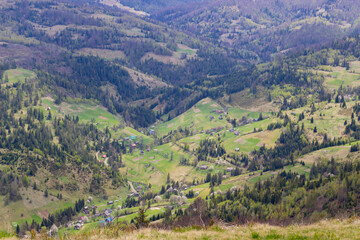 Fototapeta na wymiar Beautiful ukrainian landscape with mountains and valley on spring.Aerial view from mountain top in Slavske,Lviv region.Image for calendar design,postcard,wallpaper,wall canvas