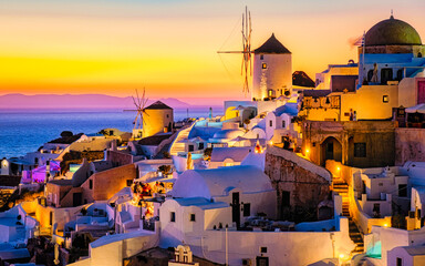 White churches an blue domes by the ocean of Oia Santorini Greece, a traditional Greek village in...