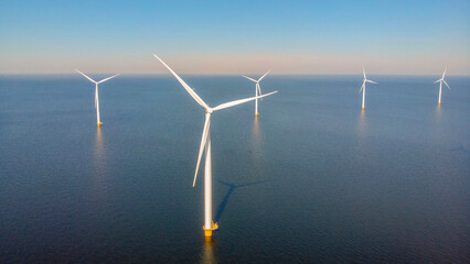 Windmill farm in the Noordoostpolder Netherlands, Green energy windmill turbine at sea and land...