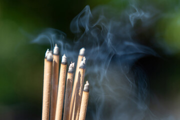 Close-up photo of smoke from a large amount of incense in temple