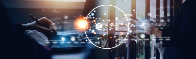 Contact us or Customer support hotline people connect. Businessman using a laptop and touching on virtual screen contact icons ( email, address, live chat, internet wifi ).