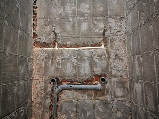 Water pipes made of polypropylene in the wall, plumbing in the house. Installation of sewer pipes in a bathroom of an apartment