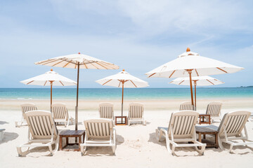lounge chairs with sun umbrella on a beach