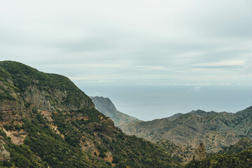 Fototapeta na wymiar View of rocky steep volcanic mountains valley and sea on atlantic island