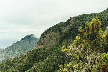 Fototapeta na wymiar View of rocky steep volcanic mountains valley in moody day on atlantic island
