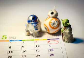 Fototapeta premium TOKYO, JAPAN - APRIL 22, 2019 - Star Wars Figures (Yoda, BB8 & R2-D2) on a calendar sheet looking at May the 4th