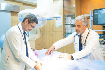Doctor with patient in operation theater at hospital.