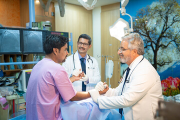 Medical technician discussing before MRI scan procedure of patient at clinic.