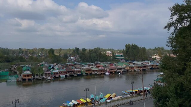 Boats in Dal Lake in summer, and the beautiful mountain range in the background in the city of Srinagar, Kashmir, India.