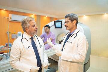 Two doctor discussing before proceeding of MRI at hospital.
