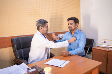 Doctor checking to patient with stethoscope at clinic.