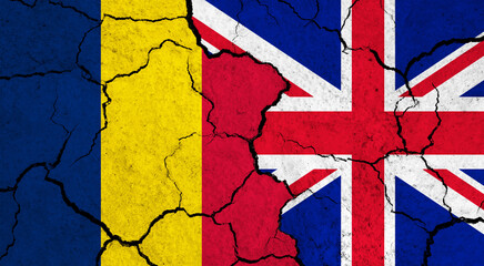 Fototapeta premium Flags of Chad and United Kingdom on cracked surface - politics, relationship concept