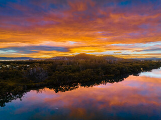 Fototapeta na wymiar A moody winter sunrise waterscape with clouds