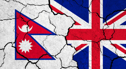 Flags of Nepal and United Kingdom on cracked surface - politics, relationship concept