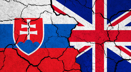 Flags of Slovakia and United Kingdom on cracked surface - politics, relationship concept