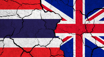 Flags of Thailand and United Kingdom on cracked surface - politics, relationship concept