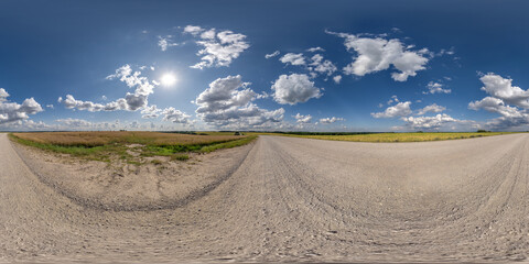360 hdri panorama on white sand gravel road with clouds on blue sky in equirectangular spherical  seamless projection, skydome replacement in drone panoramas, game development sky dome or VR content © hiv360
