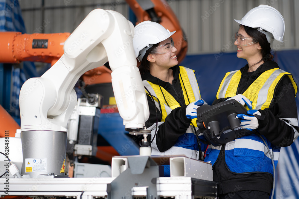 Wall mural mechanical engineering people training, programming automated ai robot arms connection at production