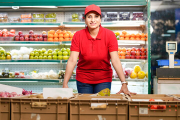 Indian woman seller giving expression at supermarket.