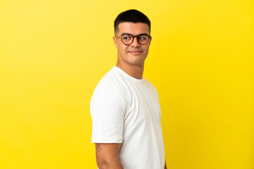 Young handsome man over isolated yellow background . Portrait