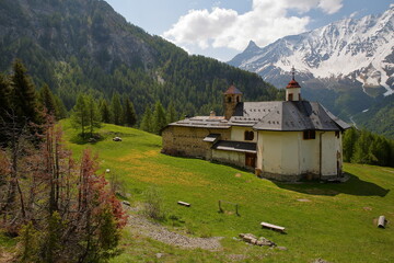 Notre Dame des Vernettes sanctuary (dated from 18 century), a church surrounded by mountains and located above Peisey Nancroix, Vanoise National Park, Northern French Alps, Tarentaise, Savoie, France