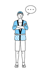 腕を組んで考える夏祭りの法被を着たシニア男性