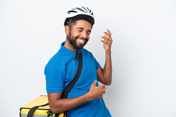 Young Brazilian man with thermal backpack isolated on white background making guitar gesture
