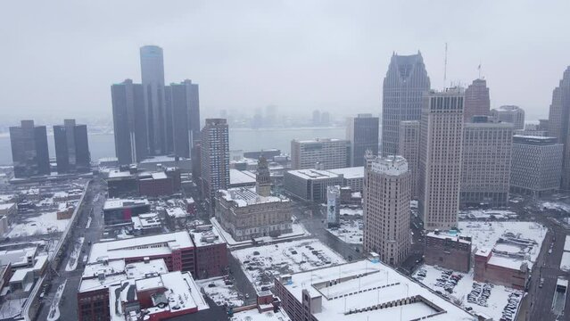 Downtown Detroit covered in snow during light snowstorm, aerial view