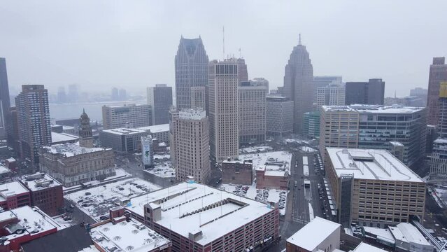 Skyline of Detroit city on foggy winter day, aerial pan left view