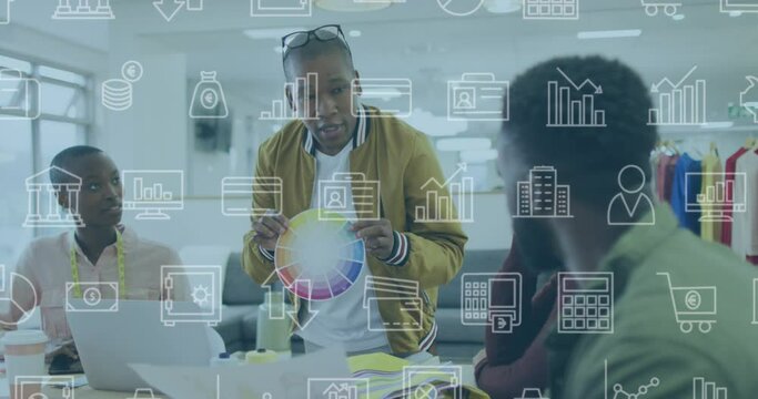 Animation of multiple icons over diverse man showing color swatch to coworkers in meeting at office