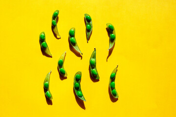 Green edamame soy beans close-up pattern on yellow background. Benefit of protein dieting concept