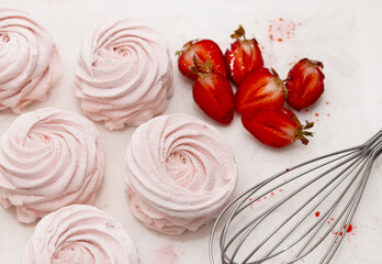 homemade marshmallow zephyr with strawberry taste on wooden boards. strawberries slice , sugar powder top view.food photography