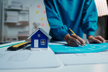 Female Industrial Engineers Look at Project Blueprints, measurements and drawing process of technical details on paper, International Labor Day Is 15 september a engineers day?