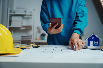 Female Industrial Engineers Look at Project Blueprints, measurements and drawing process of...
