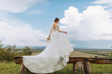 stylish bride against the background of summer mountains. the concept of a rustic wedding in the mountains, happy bohemian newlyweds.