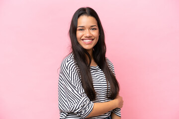 Fototapeta premium Young Colombian woman isolated on pink background laughing