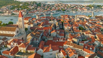 Aerial shot of magnificent Venetian city on the Adriatic Sea - Trogir, Croatia. Morning shot of old town Trogir with orange tiled roofs - 628453107