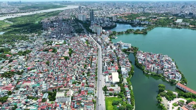 Cinematic aerial shot of Hanoi following a main road on a Sunny day in July shot in 4K, Mavic 3 Classic, Vietnam, Asia, Drone