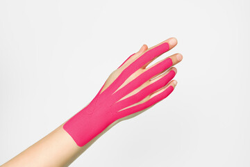 aesthetic hand taping. female hand with pink kinesio tape. hand skin care, non-surgical hand skin...