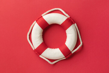 Lifebuoy on a red background, top view