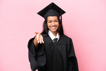Young university Colombian woman graduate isolated on pink background shaking hands for closing a...