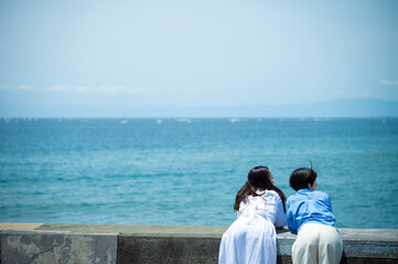 Beautiful Asian weman relaxing by the sea