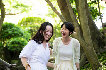 Asian female traveller enjoying nature. 
walking along the pathway in the forest park of Kamakura, exploring and admiring the spectacular nature scenic. Travel and tourism