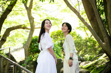 Asian female traveller enjoying nature. 
walking along the pathway in the forest park of Kamakura,...