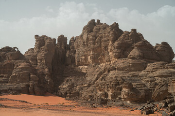 Fototapeta premium iew in the Sahara desert of Tadrart rouge tassili najer in Djanet City ,Algeria.colorful orange sand, rocky mountains