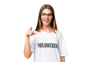 Teenager volunteer caucasian girl over isolated background surprised and pointing front